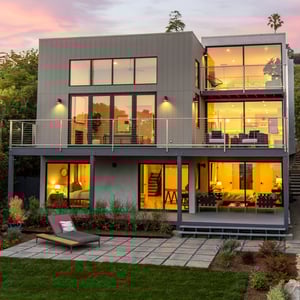 Warm and modern hillside residence with view balconies and indoor-outdoor living design.