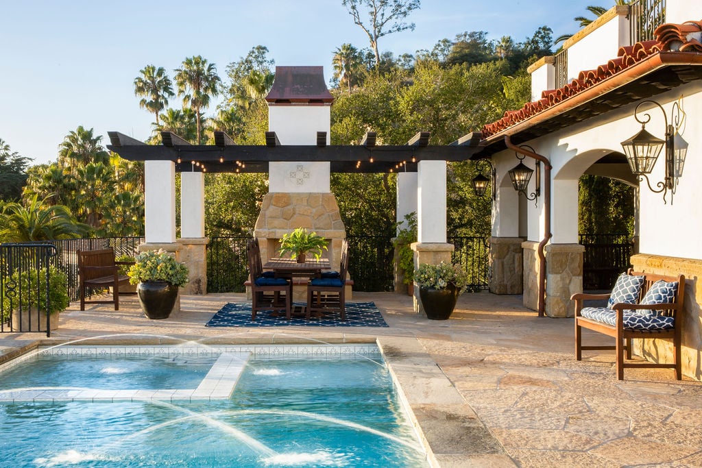 An elegant outdoor living space blends traditional home design with modern luxury in this Spanish Colonial Revival estate.