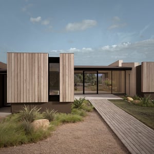 Entrance of modern residential design with wood siding, nana wall sliding door, and creative design accessed by a simple wooden path along a lush drought tolerant landscape