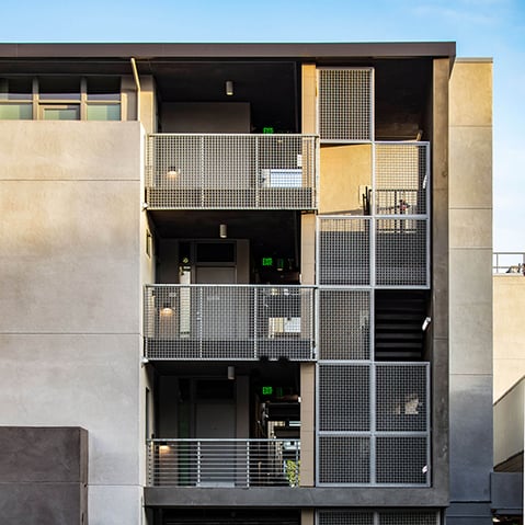 Architectural elevation showcasing balcony privacy screens for multifamily housing in a compact urban lot.