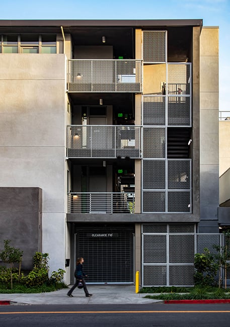Detail of the building’s metal screen facade, emphasizing privacy and ventilation in a dense urban housing context.