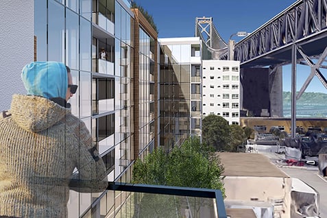 Resident enjoying Bay Bridge views from a sustainable multifamily housing unit in San Francisco’s Rincon Hill.