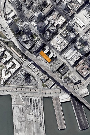 Satellite image pinpointing the multifamily housing project's tight urban footprint in a dense cityscape.