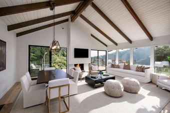 Bright and airy living room with expansive windows and mountain views, reflecting AB design studio’s residential interior design approach to openness and natural light.