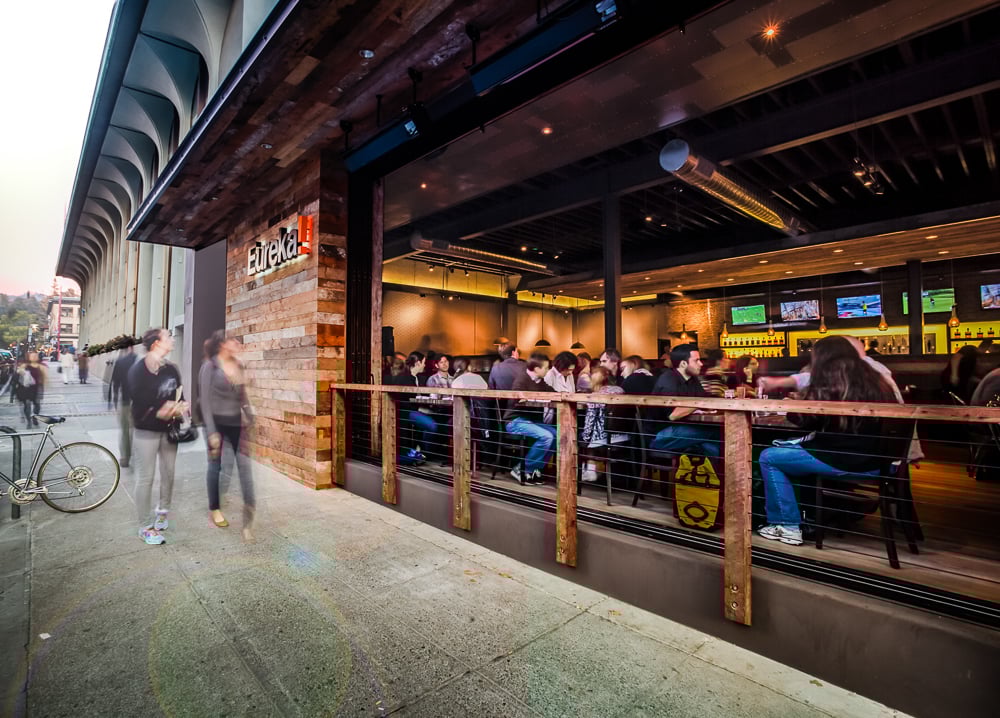 Outdoor view of Eureka! in Berkeley featuring street-facing patio dining and active foot traffic.