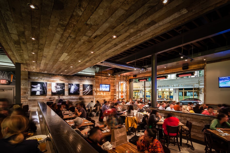 acked dining room inside Eureka! Berkeley showcasing reclaimed wood and industrial commercial architecture design.
