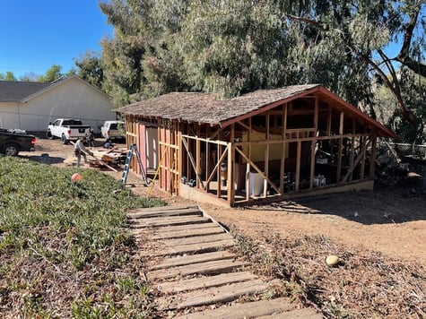 In-progress barn renovation transforming into a home office within a modern forever home plan.