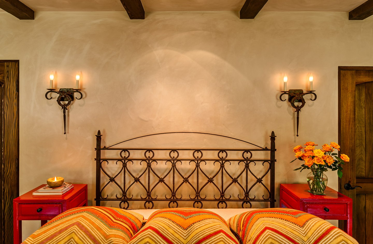 Intricate metalwork of bed frame and light fixtures of the bedroom.