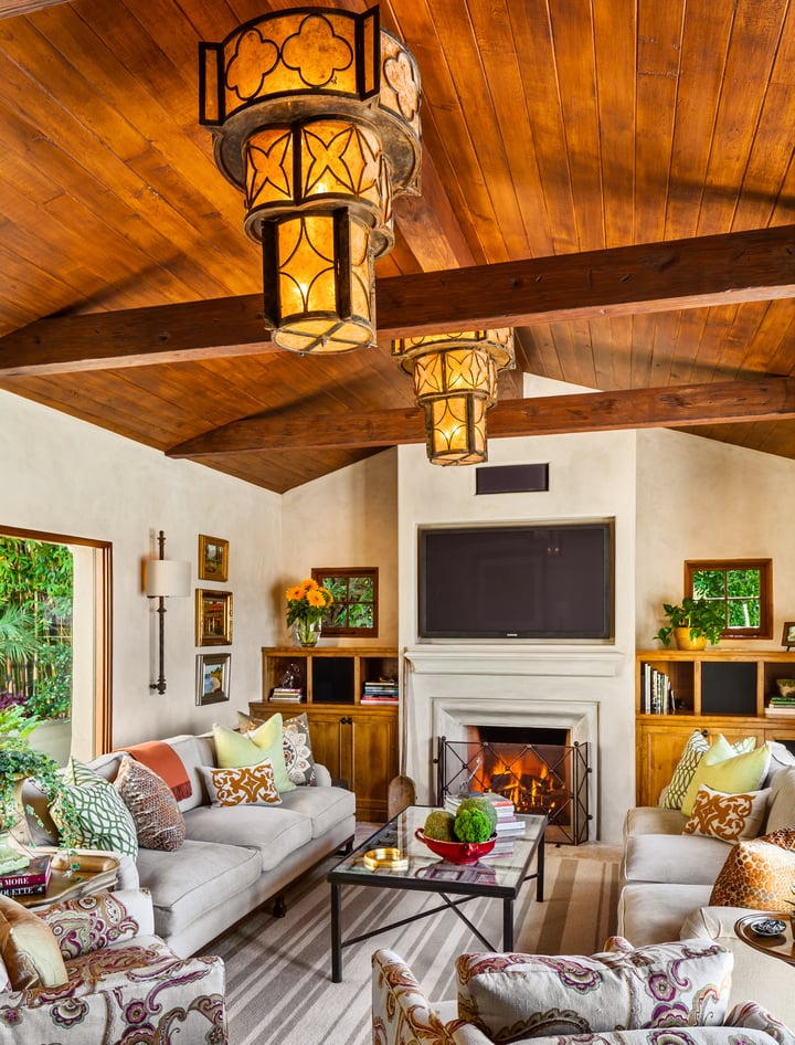 Living room and fireplace arrangement with custom light fixtures.