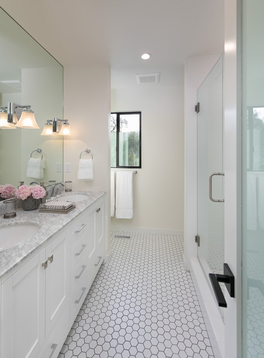 Bright, modern bathroom interior showcasing residential remodeling with updated finishes and custom interior design.