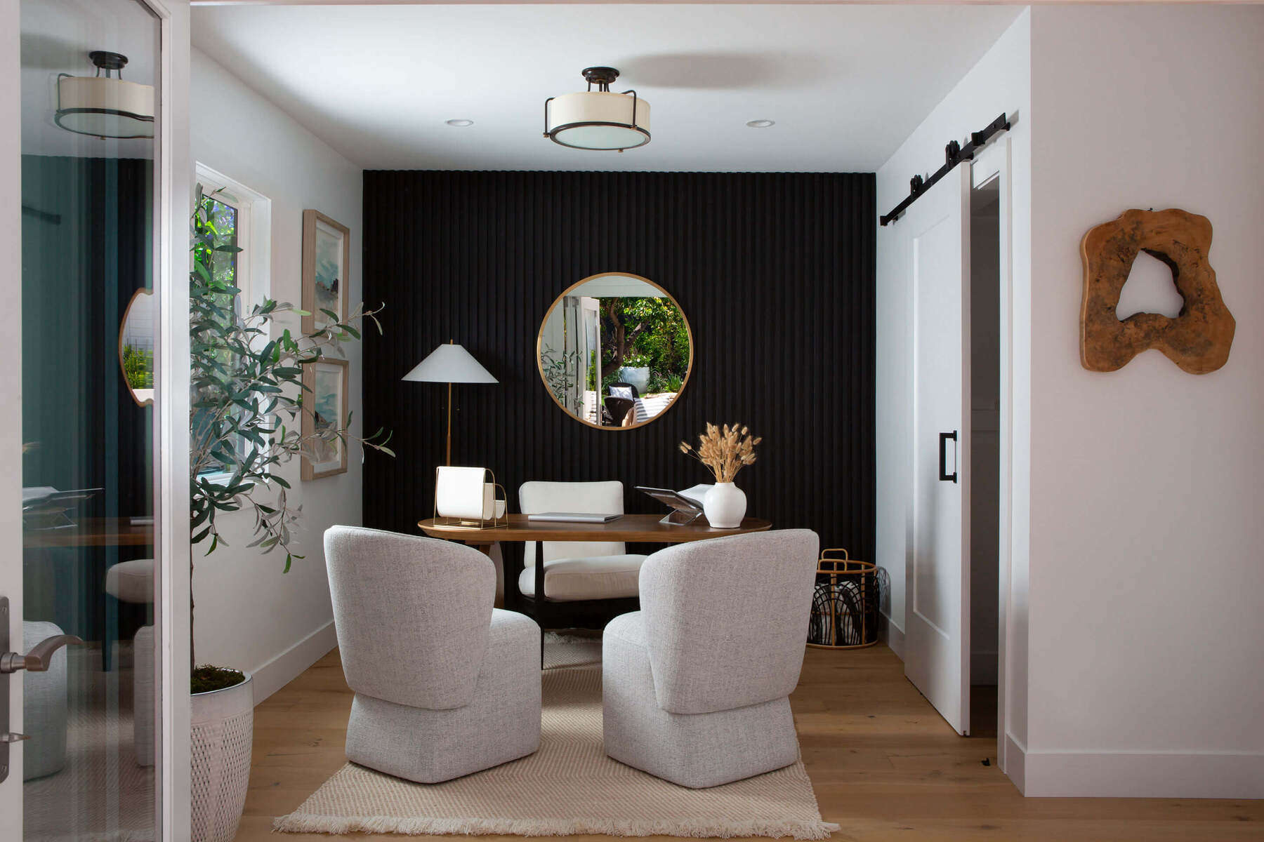 A modern interior design approach shapes this residential office with sculptural furnishings and high contrast.