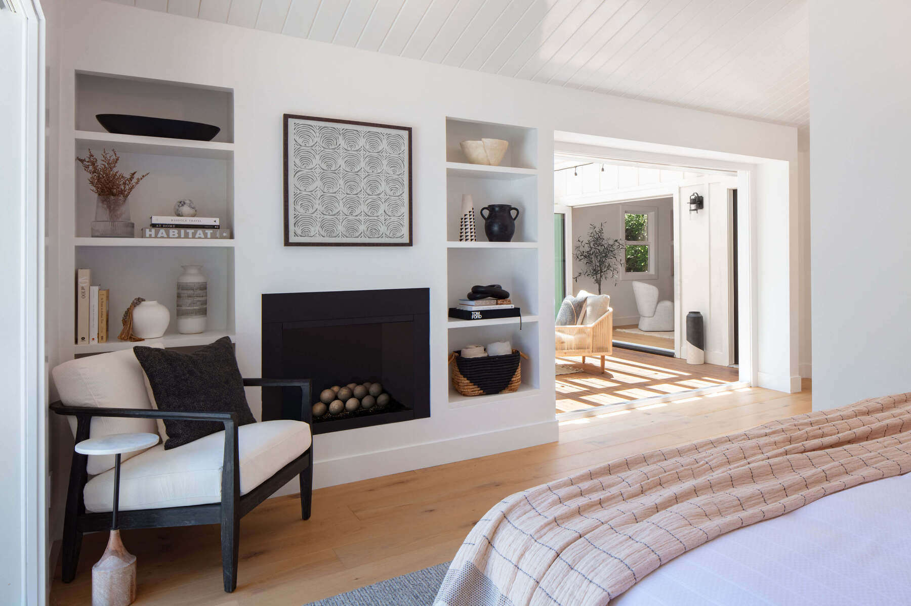 Built-in shelving and minimalist styling reflect refined residential interior design with modern material warmth.