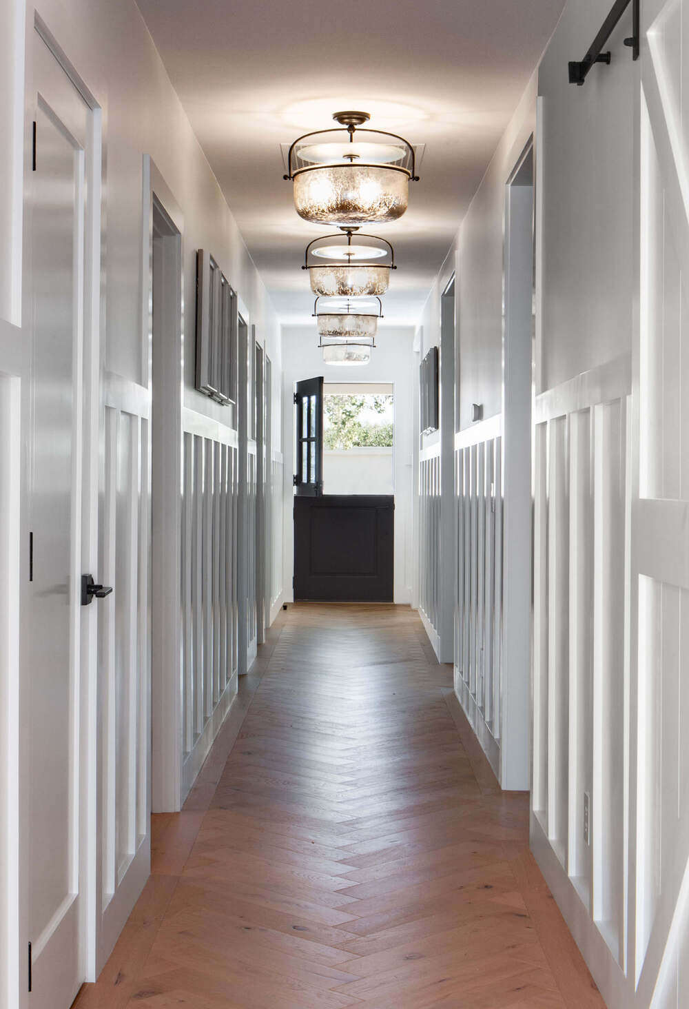 Transitional hallway design combines modern detailing with timeless textures in a residential interior.