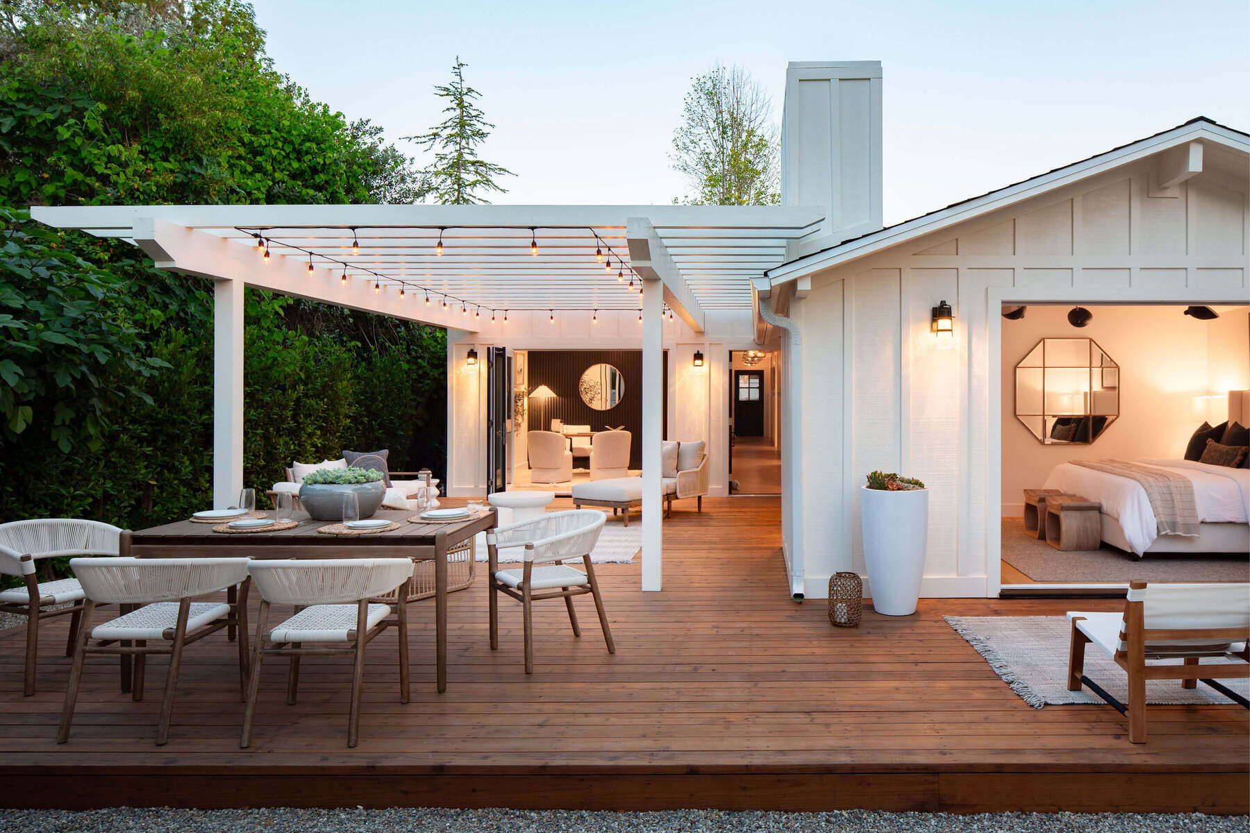 A modern outdoor living space extends this residential interior with warm textures and soft evening lighting.