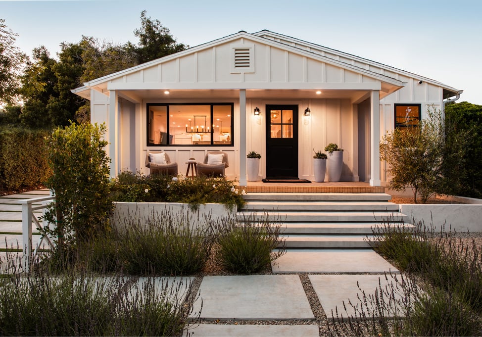Modern residential architecture meets coastal charm in this clean-lined white bungalow with a welcoming front porch.