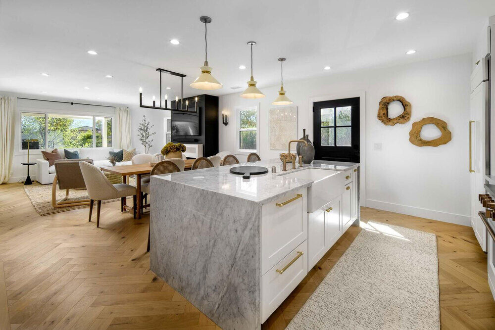 Modern residential interior design comes to life in this open-plan layout with layered lighting and material contrast.
