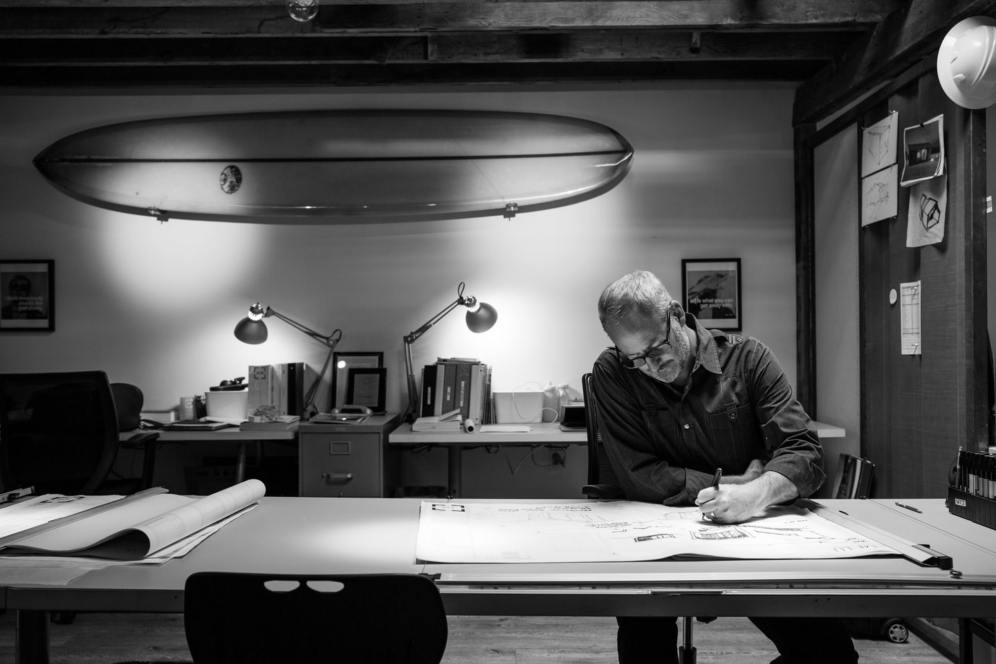 Image of architect Josh Blumer drawing at his desk in his studio