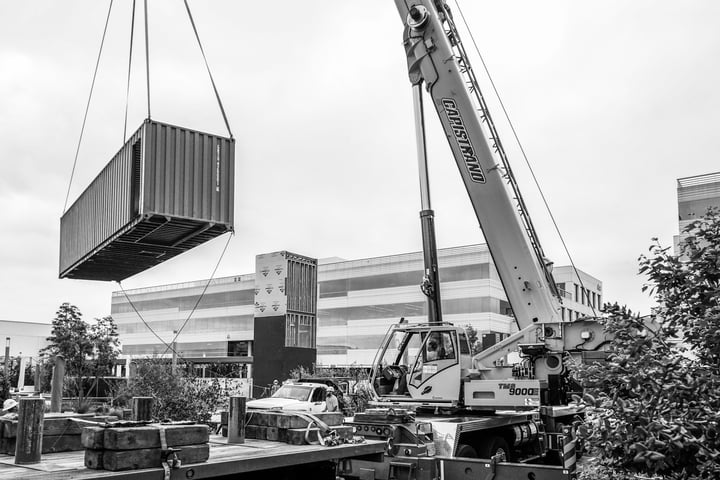Container Pavilion at Intersect-20-shipping container being craned in
