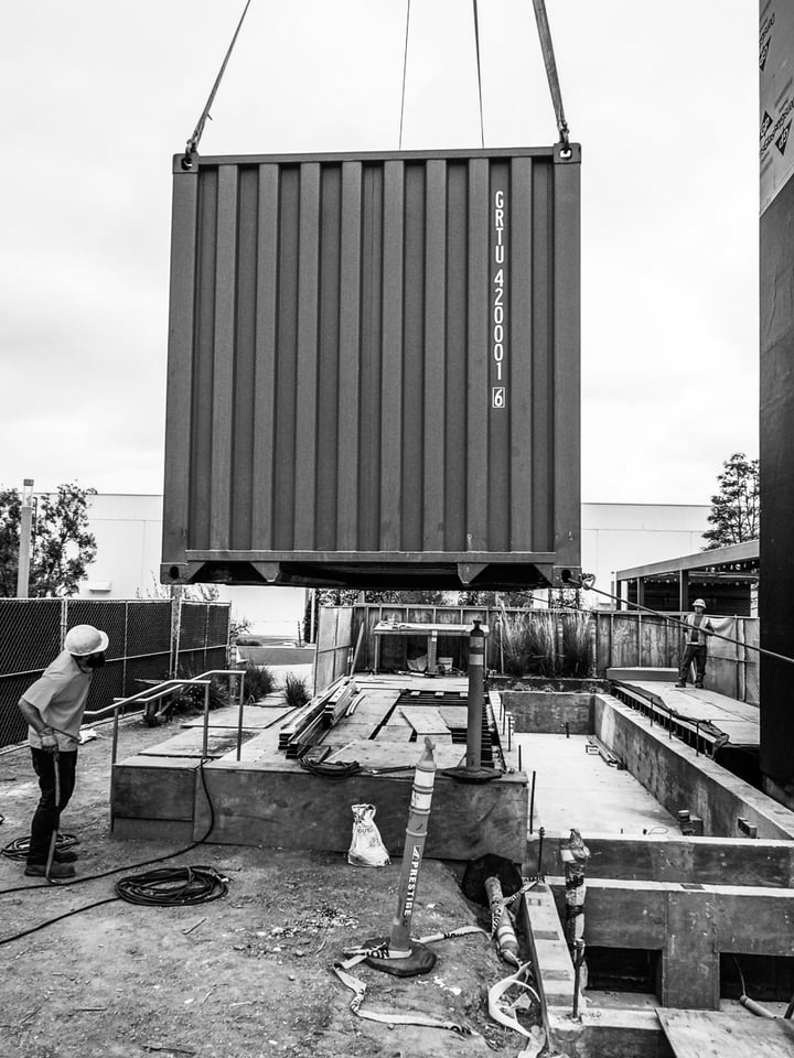 Container Pavilion at Intersect-22-shipping container being craned in
