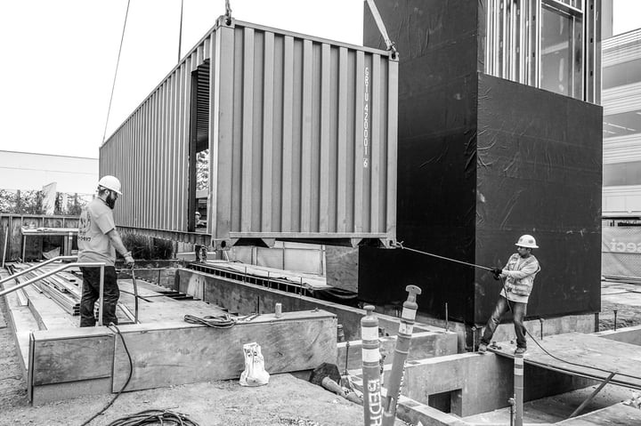 Container Pavilion at Intersect-23-shipping container being craned in