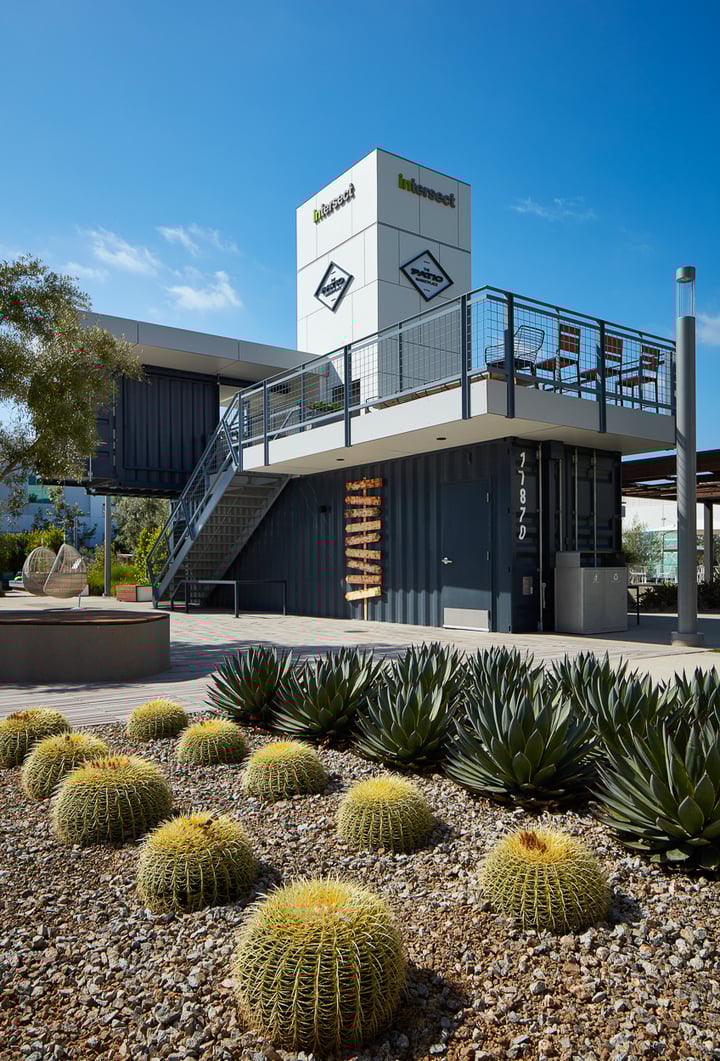 Container Pavilion at Intersect-7-side facade showing upper level patio and landscaping