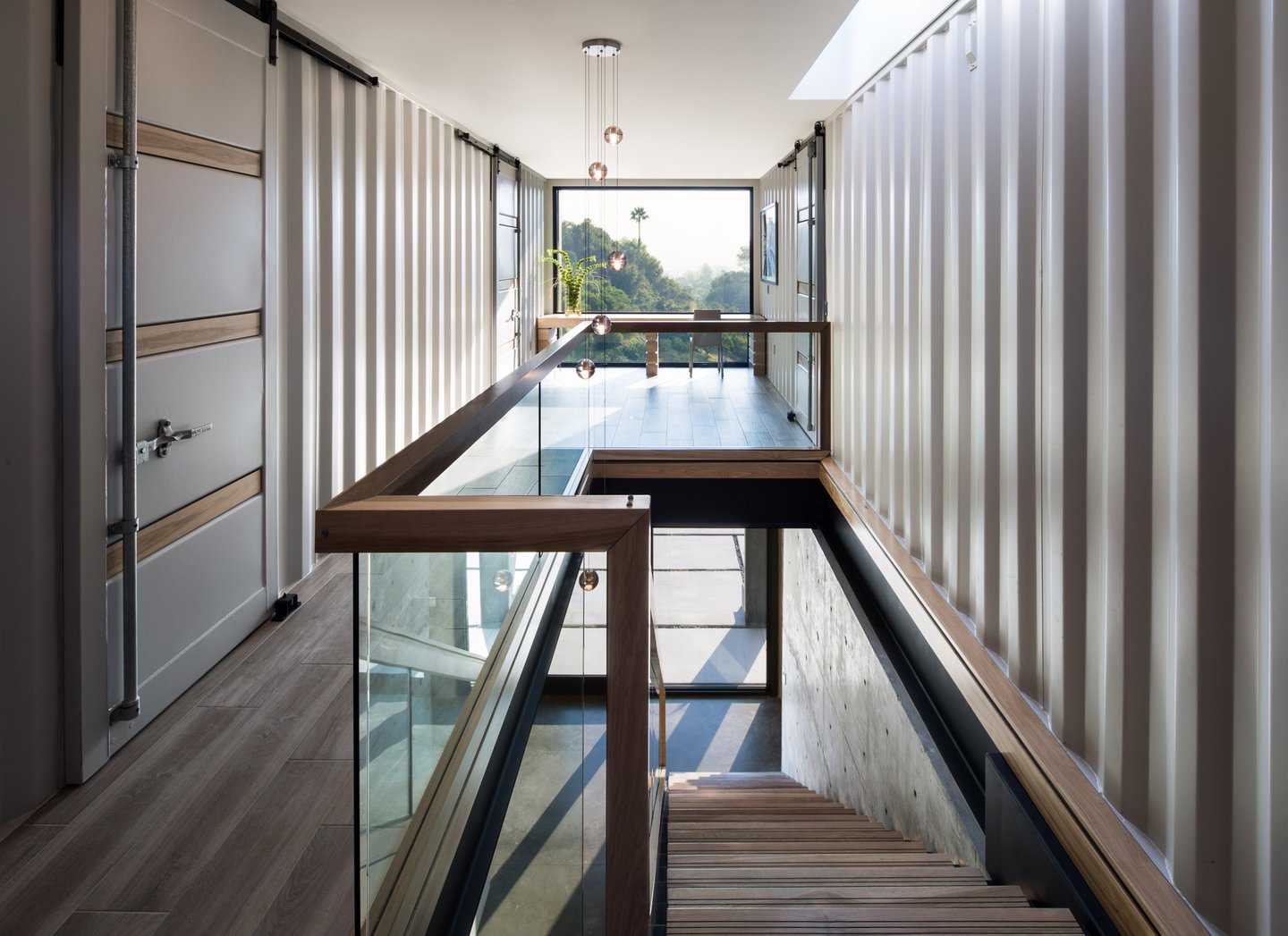 Shipping Container Residence-5-upper level hallway between shipping containers