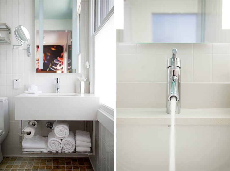 Bright and efficient boutique bathroom at Hotel Indigo featuring sleek fixtures and hospitality-focused modern design.