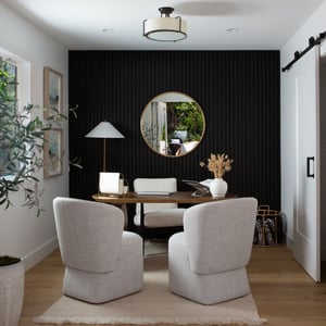 A sophisticated home office with a textured wall of ebonized wood and stunning interior decor and furnishings.